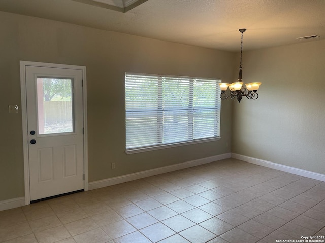 812 33rd St, Hondo, TX 78861 - unfurnished dining area with healthy amount of natural light, a chandelier, and light tile patterned floors