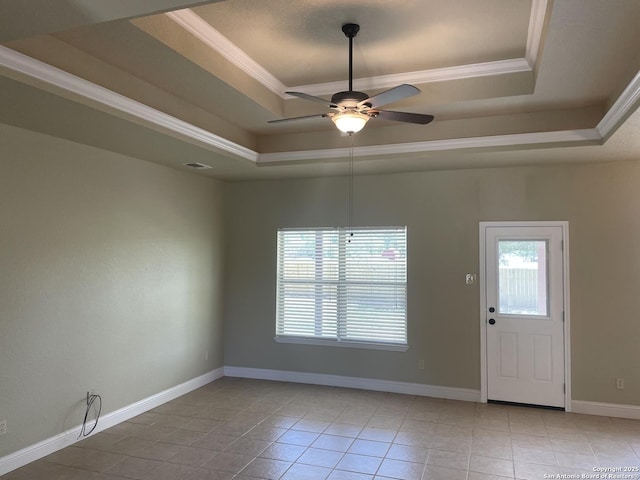 812 33rd St, Hondo, TX 78861 - tiled empty room featuring a tray ceiling, healthy amount of natural light, a ceiling fan, and ornamental molding