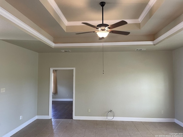 812 33rd St, Hondo, TX 78861 - spare room with a tray ceiling, ceiling fan, crown molding, and tile patterned floors