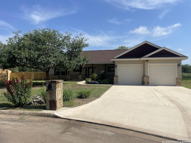 812 33rd St, Hondo, TX 78861 - view of front facade with an attached garage, concrete driveway, and stucco siding