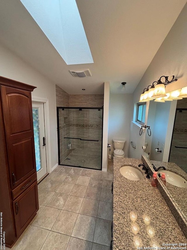 3716 Scenic Dr, Schertz, TX 78108 - bathroom featuring a skylight, a shower stall, vanity, and tile patterned flooring
