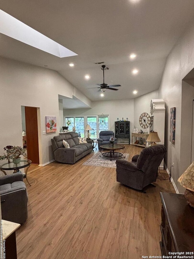 3716 Scenic Dr, Schertz, TX 78108 - living room featuring lofted ceiling, wood finished floors, a ceiling fan, a skylight, and recessed lighting