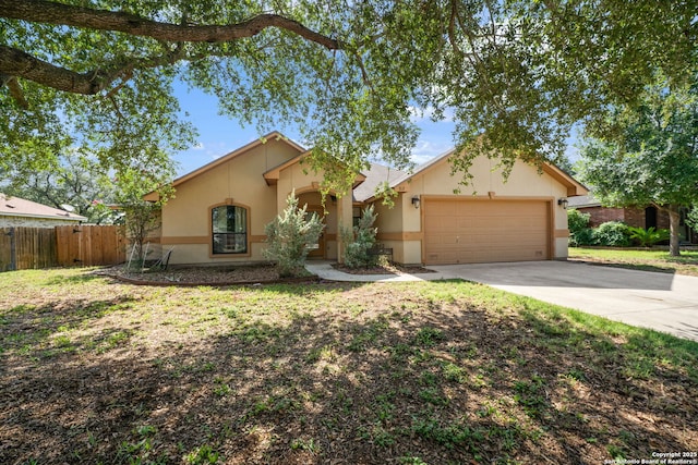 312 Bunker Hl, Pleasanton, TX 78064 - view of front of property featuring stucco siding, a garage, and driveway