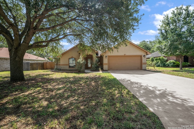 312 Bunker Hl, Pleasanton, TX 78064 - view of front of home featuring an attached garage, stucco siding, and driveway