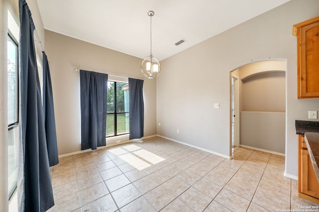 312 Bunker Hl, Pleasanton, TX 78064 - unfurnished dining area featuring light tile patterned floors, arched walkways, and a chandelier