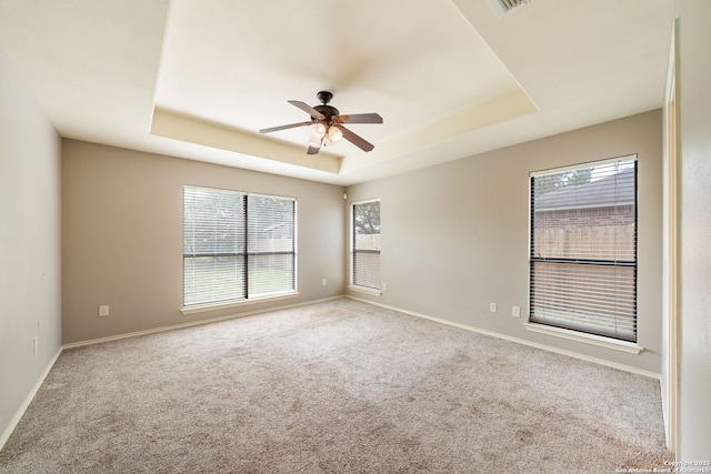 312 Bunker Hl, Pleasanton, TX 78064 - spare room with a tray ceiling, plenty of natural light, carpet floors, and ceiling fan