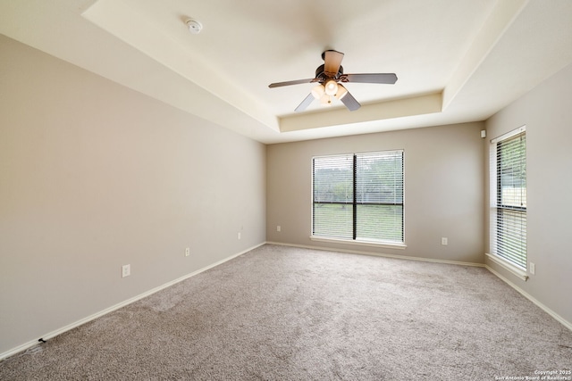 312 Bunker Hl, Pleasanton, TX 78064 - spare room featuring a raised ceiling, light colored carpet, a smoke detector, and ceiling fan