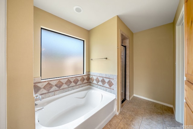 312 Bunker Hl, Pleasanton, TX 78064 - full bathroom featuring a bath, a stall shower, and tile patterned floors