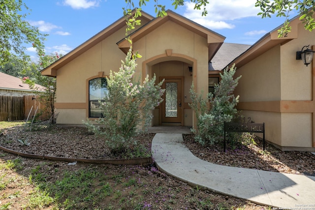 312 Bunker Hl, Pleasanton, TX 78064 - view of exterior entry featuring stucco siding and roof with shingles