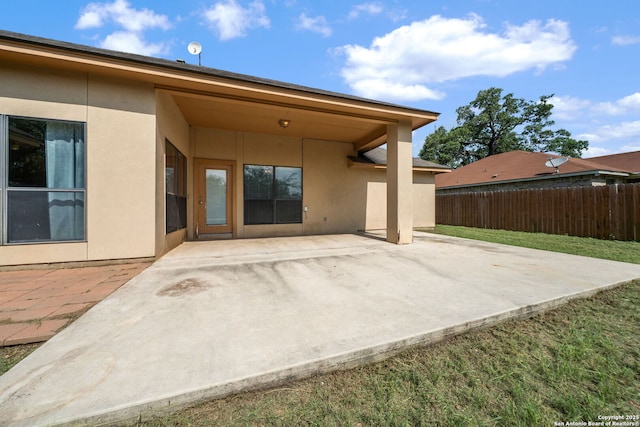 312 Bunker Hl, Pleasanton, TX 78064 - back of property featuring stucco siding and a patio area