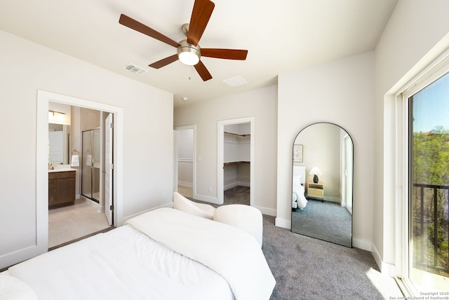 419 Ira Ave Unit 1102, San Antonio, TX 78209 - bedroom with light carpet, ceiling fan, connected bathroom, and a walk in closet