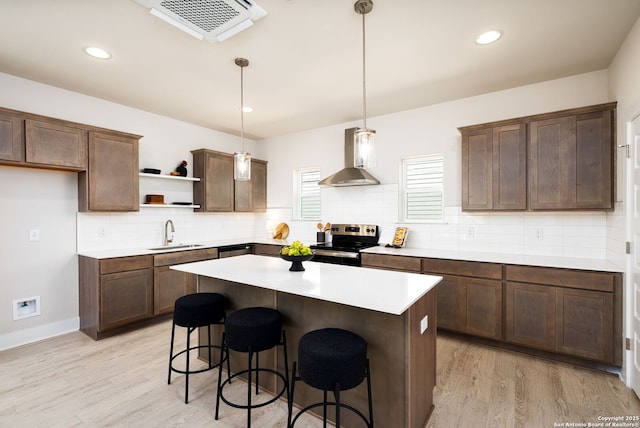 419 Ira Ave Unit 1102, San Antonio, TX 78209 - kitchen featuring electric range, wall chimney range hood, open shelves, light wood-type flooring, and recessed lighting