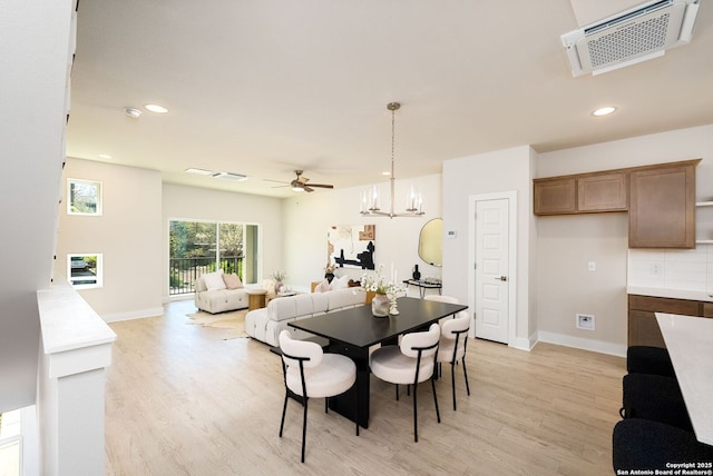 419 Ira Ave Unit 1102, San Antonio, TX 78209 - dining space featuring light wood finished floors, recessed lighting, ceiling fan, and a chandelier