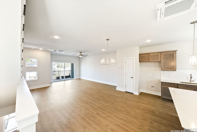 419 Ira Ave Unit 2101, San Antonio, TX 78209 - unfurnished living room with recessed lighting, wood finished floors, a chandelier, and a ceiling fan
