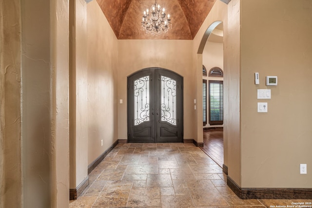 1437 Decanter, New Braunfels, TX 78132 - entryway with arched walkways, stone tile floors, french doors, a chandelier, and high vaulted ceiling