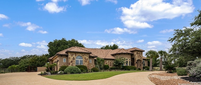 1437 Decanter, New Braunfels, TX 78132 - mediterranean / spanish-style house featuring stone siding, a tiled roof, curved driveway, and stucco siding