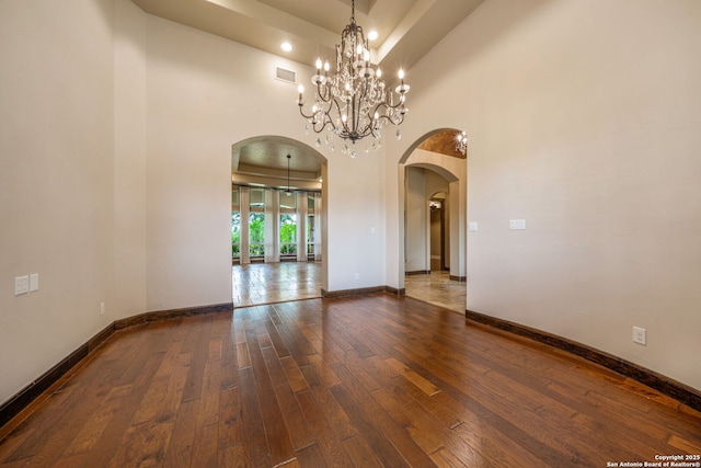 1437 Decanter, New Braunfels, TX 78132 - unfurnished room featuring arched walkways, hardwood / wood-style floors, a chandelier, recessed lighting, and a towering ceiling