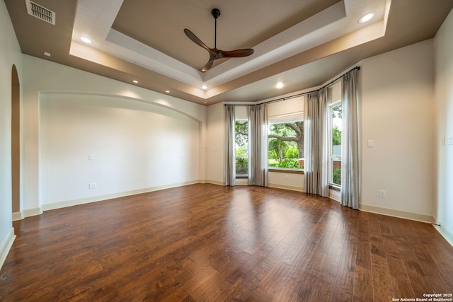 1437 Decanter, New Braunfels, TX 78132 - empty room featuring arched walkways, a ceiling fan, a raised ceiling, wood finished floors, and recessed lighting