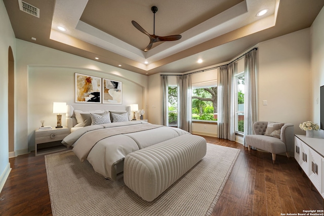 1437 Decanter, New Braunfels, TX 78132 - bedroom featuring a raised ceiling, arched walkways, dark wood-style flooring, access to outside, and recessed lighting