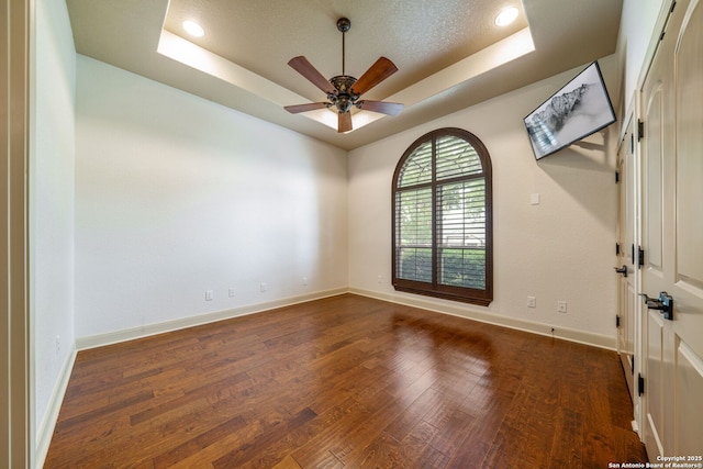 1437 Decanter, New Braunfels, TX 78132 - unfurnished room featuring a tray ceiling, wood finished floors, and a ceiling fan