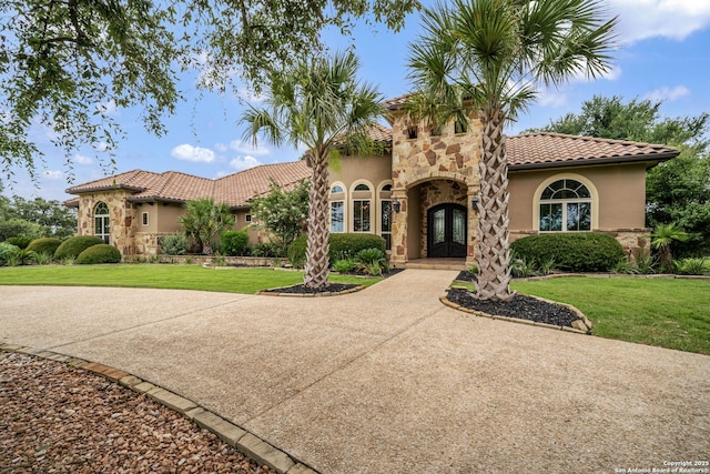 1437 Decanter, New Braunfels, TX 78132 - mediterranean / spanish house featuring french doors, stucco siding, a tiled roof, and a front lawn