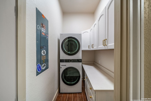 1437 Decanter, New Braunfels, TX 78132 - laundry area featuring estacked washer and dryer, dark wood finished floors, cabinet space, and a textured wall