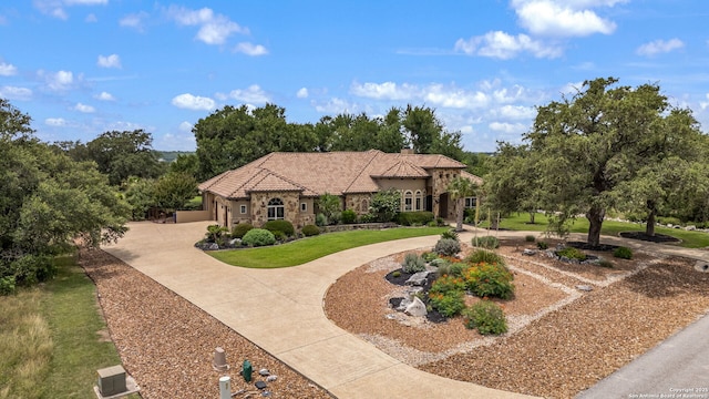 1437 Decanter, New Braunfels, TX 78132 - mediterranean / spanish-style home featuring curved driveway, stone siding, stucco siding, a chimney, and a tiled roof