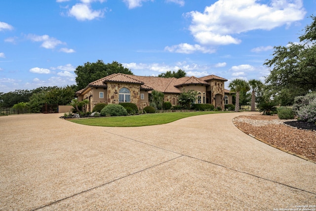 1437 Decanter, New Braunfels, TX 78132 - mediterranean / spanish home featuring curved driveway, stone siding, a tile roof, and stucco siding