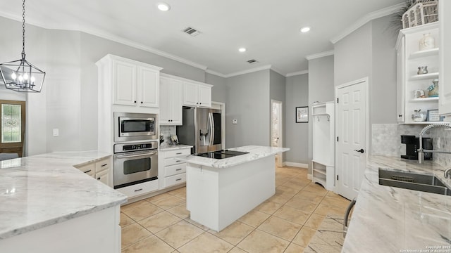 212 Wentworth, Spring Branch, TX 78070 - kitchen featuring appliances with stainless steel finishes, tasteful backsplash, a center island, a chandelier, and open shelves