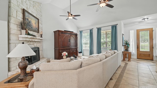 212 Wentworth, Spring Branch, TX 78070 - living room with light tile patterned floors, a stone fireplace, a ceiling fan, inlaid floor details, and high vaulted ceiling