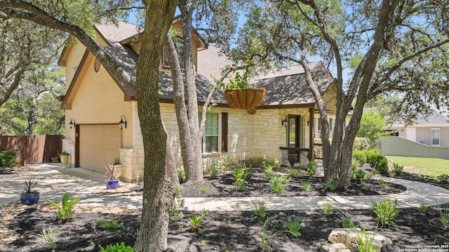 212 Wentworth, Spring Branch, TX 78070 - view of front of home with a shingled roof, driveway, stone siding, stucco siding, and a garage