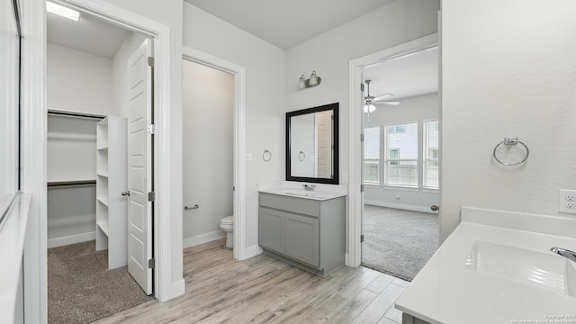 1606 Folk Victorian, New Braunfels, TX 78132 - bathroom with vanity, ceiling fan, wood finished floors, and a walk in closet
