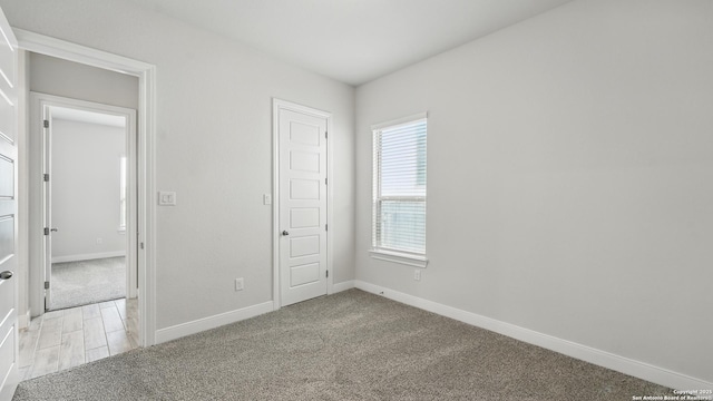 1606 Folk Victorian, New Braunfels, TX 78132 - unfurnished bedroom with baseboards and light carpet