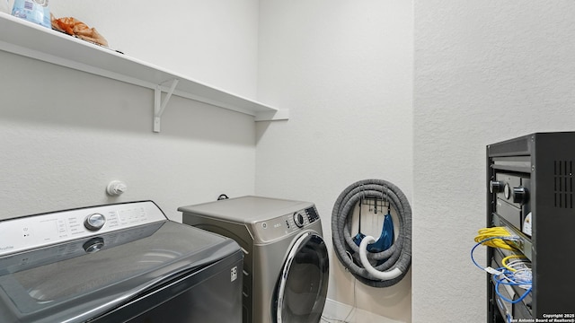 1606 Folk Victorian, New Braunfels, TX 78132 - washroom featuring independent washer and dryer and a textured wall