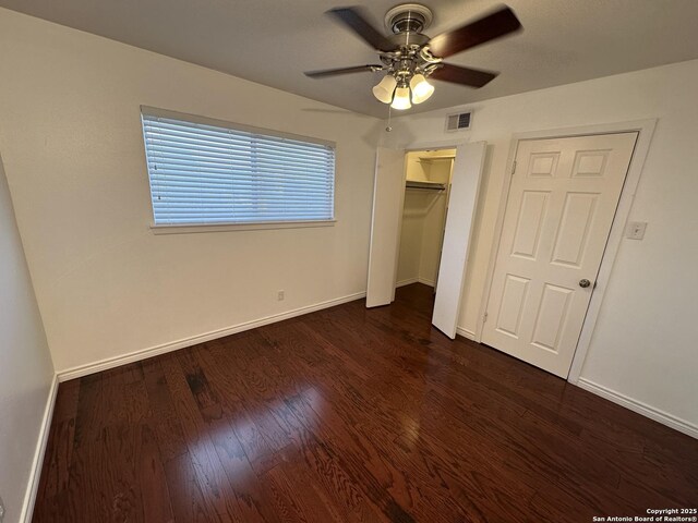 105 W Silver Sands Unit 105A, San Antonio, TX 78216 - unfurnished bedroom featuring dark wood-style floors, ceiling fan, and a closet