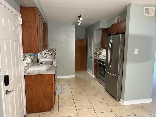 105 W Silver Sands Unit 105A, San Antonio, TX 78216 - kitchen featuring appliances with stainless steel finishes, backsplash, and light tile patterned floors