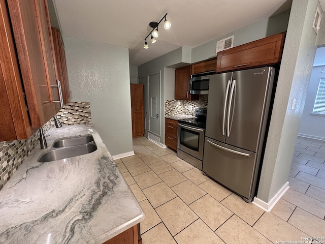 105 W Silver Sands Unit 105A, San Antonio, TX 78216 - kitchen with stainless steel appliances, backsplash, light tile patterned floors, and light countertops