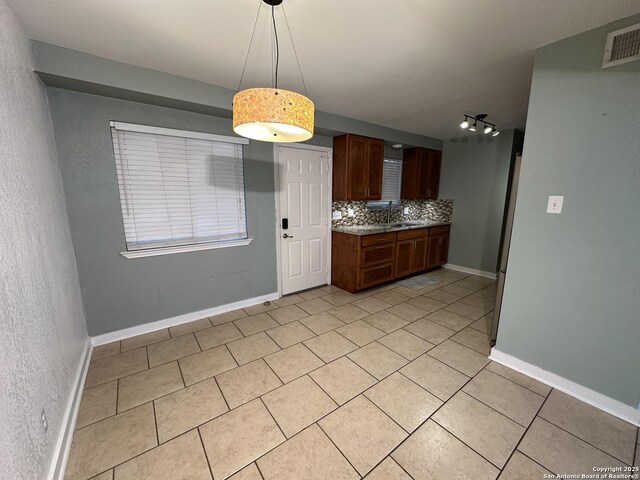 105 W Silver Sands Unit 105A, San Antonio, TX 78216 - kitchen featuring tasteful backsplash, light tile patterned floors, pendant lighting, and rail lighting