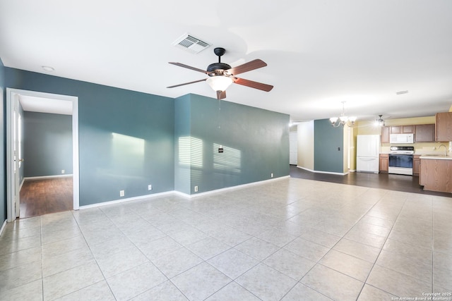 9003 Timber Frk, San Antonio, TX 78250 - unfurnished living room with ceiling fan, tile patterned flooring, and a chandelier