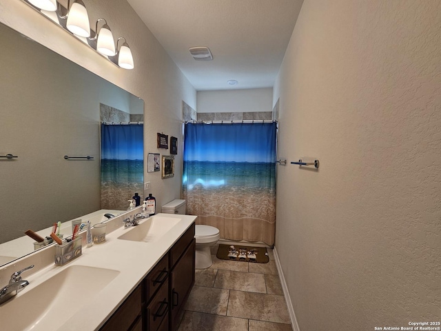 111 Lone Fls, Universal City, TX 78148 - full bath featuring a textured wall, double vanity, and curtained shower