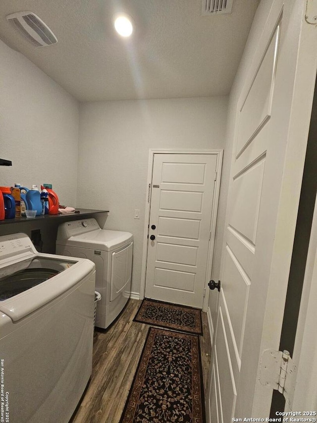 111 Lone Fls, Universal City, TX 78148 - laundry area featuring washer and clothes dryer, dark wood-type flooring, and a textured ceiling