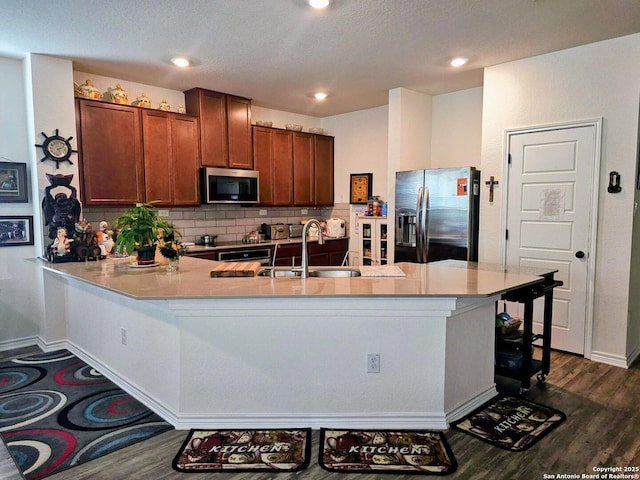 111 Lone Fls, Universal City, TX 78148 - kitchen featuring stainless steel appliances, a peninsula, dark wood-style flooring, light countertops, and recessed lighting