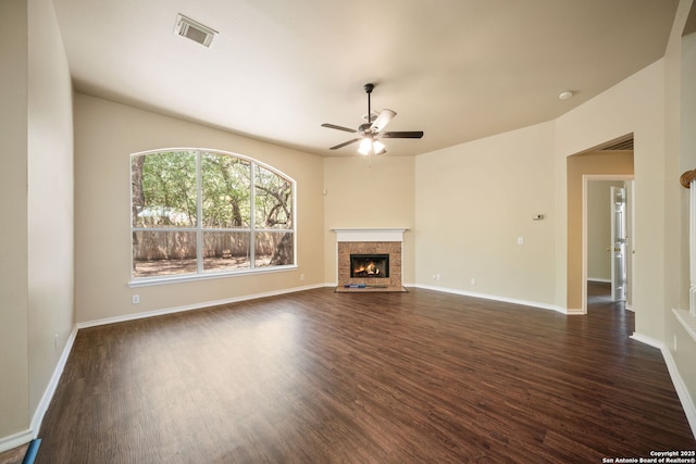 3837 Arroyo Seco, Schertz, TX 78154 - unfurnished living room with dark wood-style floors, ceiling fan, and a fireplace