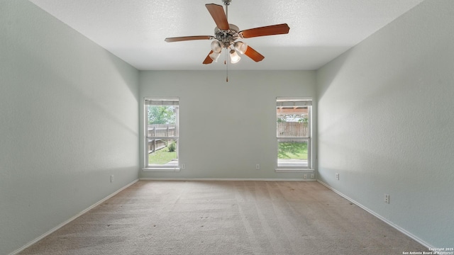 2166 Jolie, New Braunfels, TX 78130 - empty room with healthy amount of natural light, a ceiling fan, and carpet flooring