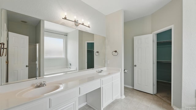 2166 Jolie, New Braunfels, TX 78130 - full bathroom featuring a garden tub, double vanity, tile patterned floors, a spacious closet, and a shower