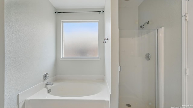 2166 Jolie, New Braunfels, TX 78130 - full bath featuring a shower stall, a garden tub, and a textured wall