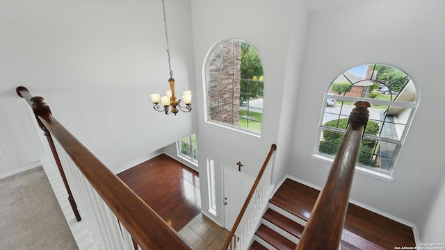 2166 Jolie, New Braunfels, TX 78130 - staircase featuring plenty of natural light, a chandelier, a towering ceiling, and wood finished floors