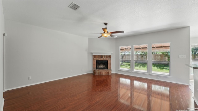 2166 Jolie, New Braunfels, TX 78130 - unfurnished living room with a ceiling fan, wood finished floors, and a brick fireplace