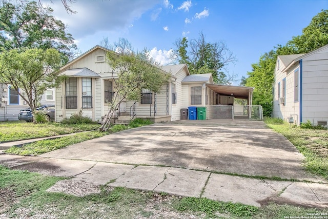 613 Drake Ave, San Antonio, TX 78204 - view of front of property with driveway, board and batten siding, and a carport