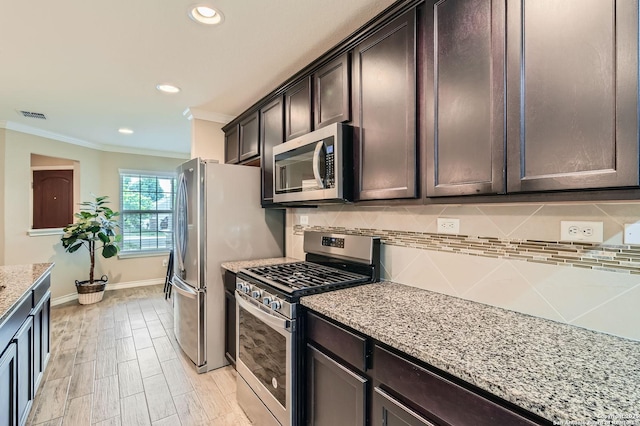 3354 Blossom Row, San Antonio, TX 78253 - kitchen featuring stainless steel appliances, ornamental molding, dark brown cabinets, light stone countertops, and backsplash